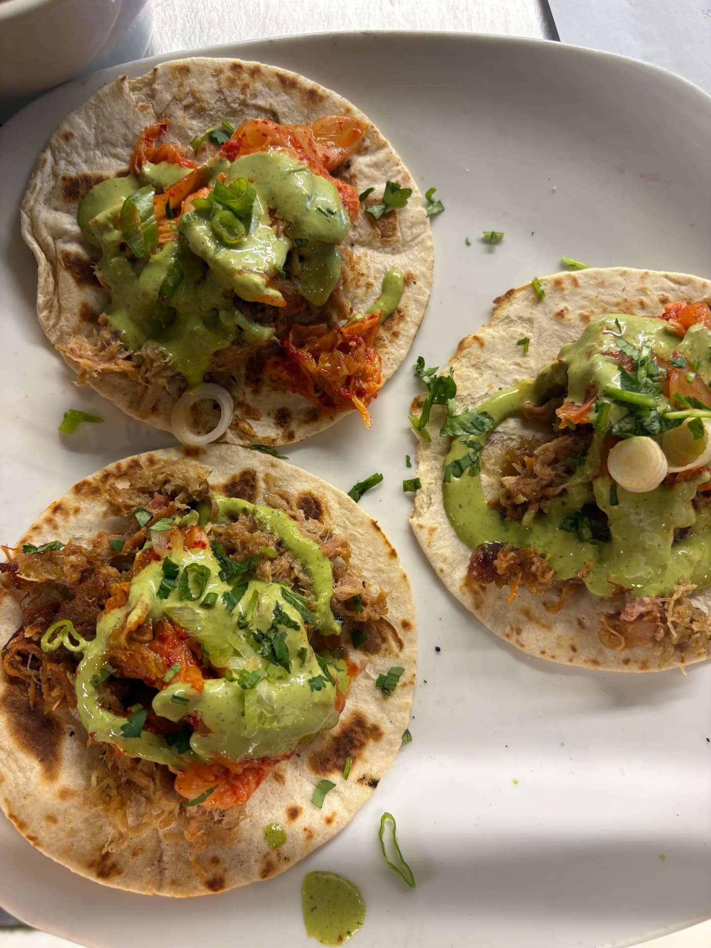 Carnitas tacos with avocado crema